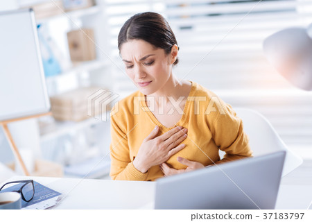 Upset woman touching her heart while having 37183797