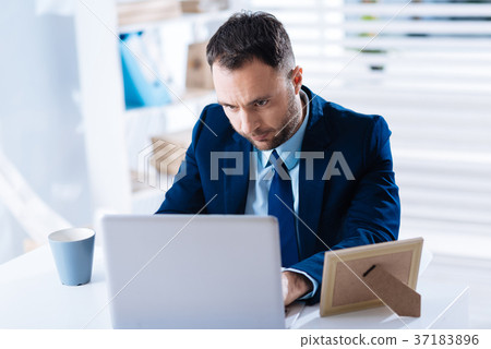 Thoughtful clever worker struggling while making Thoughtful clever worker struggling while making 37183896