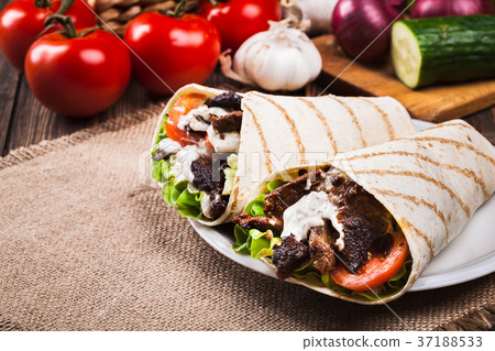 Tasty fresh wrap sandwich with beef and vegetables Tasty fresh wrap sandwich with beef and vegetables 37188533