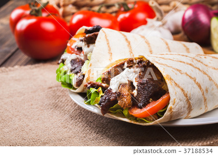 Tasty fresh wrap sandwich with beef and vegetables 37188534