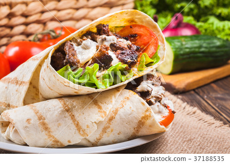 Tasty fresh wrap sandwich with beef and vegetables 37188535