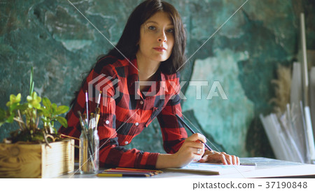 Young woman artist painting sketch on paper 37190848