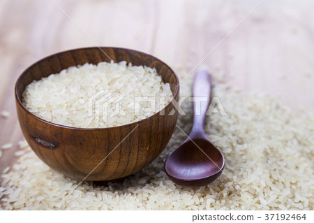 Raw rice in a wooden bowl Raw rice in a wooden bowl 37192464