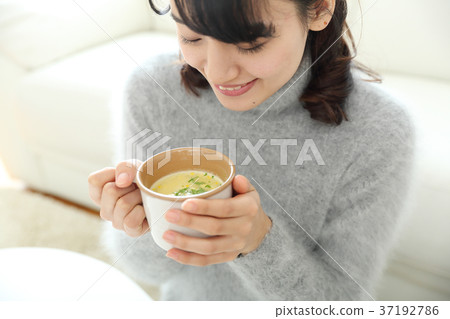 Young girl drinking soup Young girl drinking soup 37192786