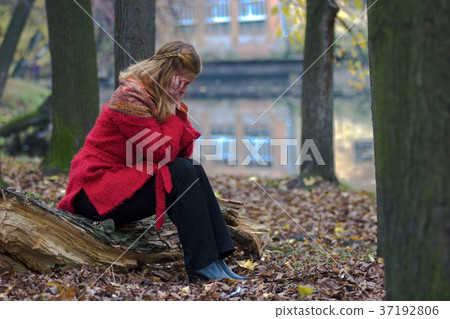 worried woman in the park worried woman in the park 37192806