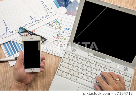 Businessman working on notebook and moblie Businessman working on notebook and moblie 37194712