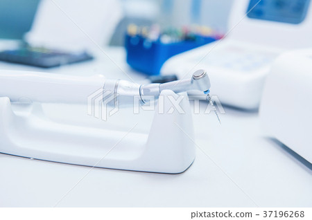 Assistant's hands configures dental equipment 37196268