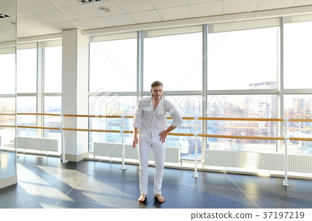 Male dancer making one arm handstand. 37197219