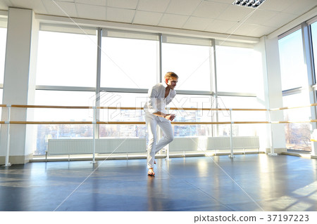 Young blonde dancer enjoys winning in white suit Young blonde dancer enjoys winning in white suit 37197223