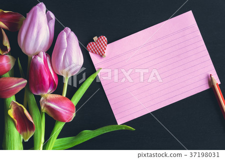 Tulips bouquet and a striped paper note Tulips bouquet and a striped paper note 37198031