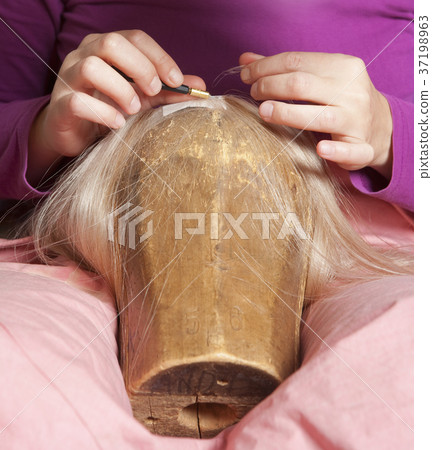 Professional Wig Maker Working in her Workshop. Professional Wig Maker Working in her Workshop. 37198963