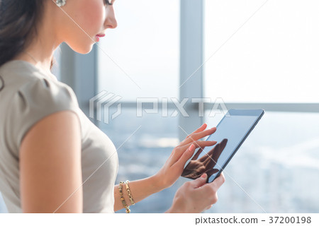 Side view photo of young female teleworker using Side view photo of young female teleworker using 37200198