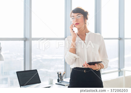 Happy smiling businesswoman having a business call 37200203