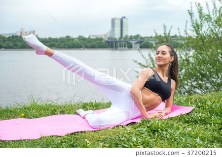 Woman in a yoga pose with her arm reaching 37200215