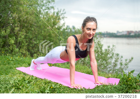 Fit woman doing push ups exercise fitness training Fit woman doing push ups exercise fitness training 37200218
