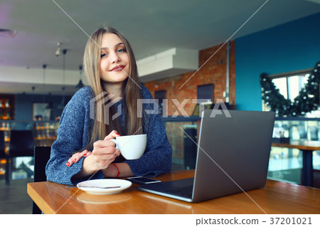 beautiful young girl resting in a cafe. Toned beautiful young girl resting in a cafe. Toned 37201021