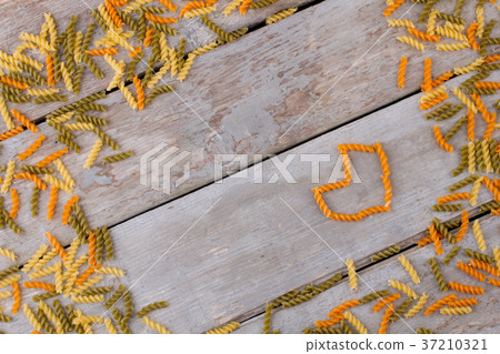 Colorful pasta on old wooden table. Colorful pasta on old wooden table. 37210321