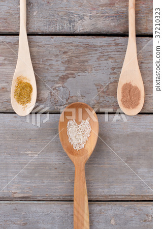 Wooden spoons with seasoning, top view. Wooden spoons with seasoning, top view. 37210323