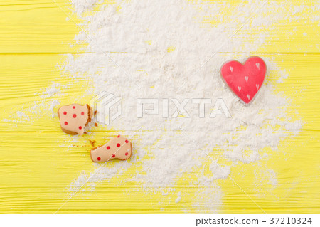 Flour and cookies on yellow background. Flour and cookies on yellow background. 37210324