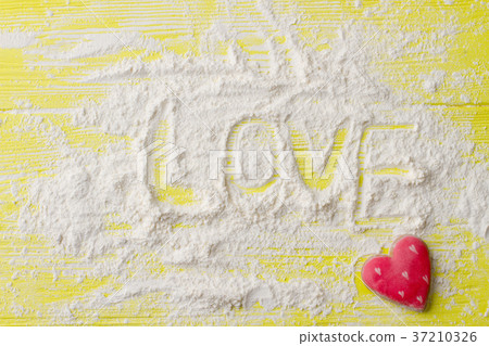 Word love written on sugar powder. 37210326