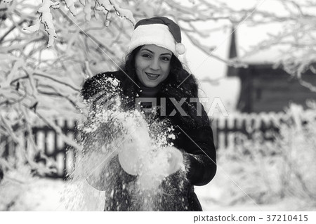 Beautiful girl in winter snowy monochrome Beautiful girl in winter snowy monochrome 37210415