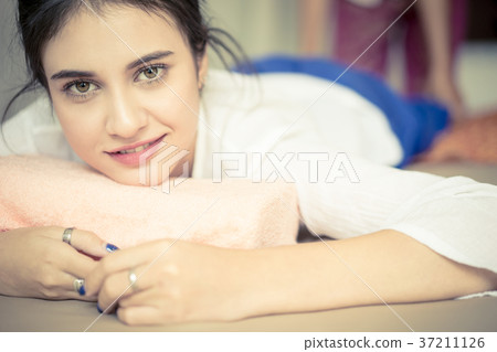 Portrait of a woman getting massaged in Thai Spa Portrait of a woman getting massaged in Thai Spa 37211126