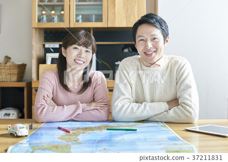 A couple traveling together on a map A couple traveling together on a map 37211831