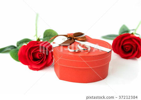 Red rose and heart-shaped box on white Red rose and heart-shaped box on white 37212384