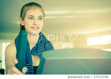 Woman looking motivated working out on treadmill 37213356