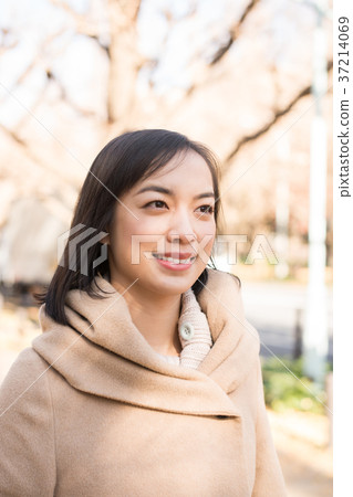 A woman in a coat A woman in a coat 37214069