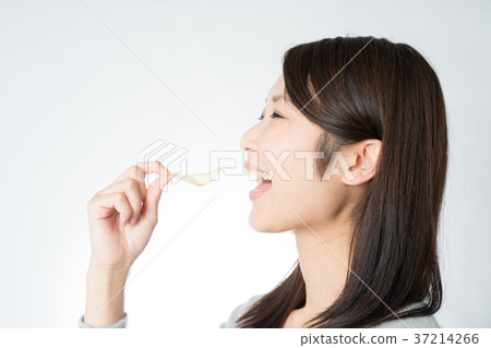 A woman eating potato chips A woman eating potato chips 37214266