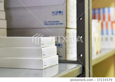 Drug boxes in a shelf in a pharmacy. Store. 37214379