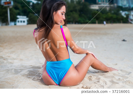 Slender seductive female model relaxing, sitting 37216001