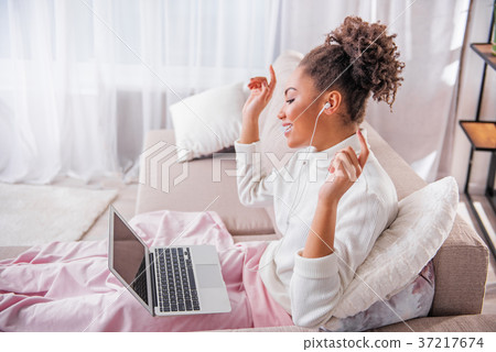 Cheerful young woman listening to music and Cheerful young woman listening to music and 37217674