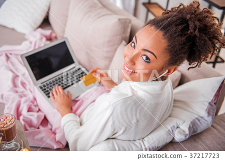 Cheerful african girl paying for purchase in Cheerful african girl paying for purchase in 37217723