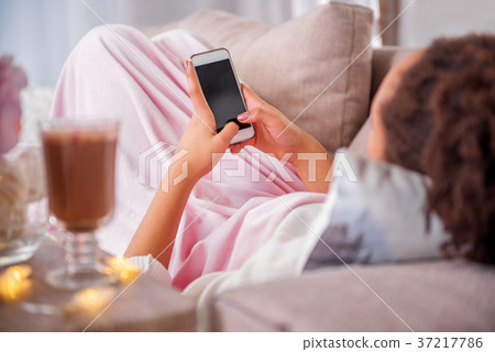 Girl using smartphone at home Girl using smartphone at home 37217786