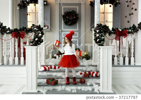 Happy little girl holding a lot of boxes with Happy little girl holding a lot of boxes with 37217787