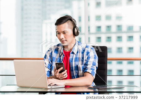 Young asian man having video conference Young asian man having video conference 37217999