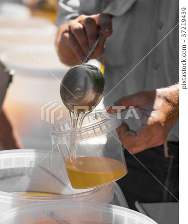 the beekeeper sells honey in the market the beekeeper sells honey in the market 37219439