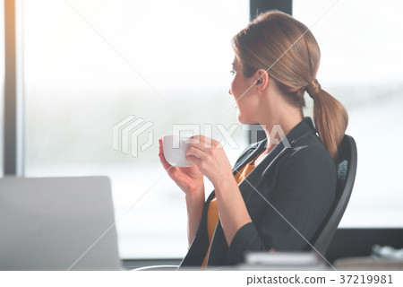 Happy girl tasting cup of liquid Happy girl tasting cup of liquid 37219981