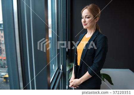 Serious girl situating in office 37220351