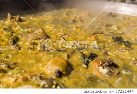 Cooking Valencian paella. Typical cuisine of the Cooking Valencian paella. Typical cuisine of the 37221444