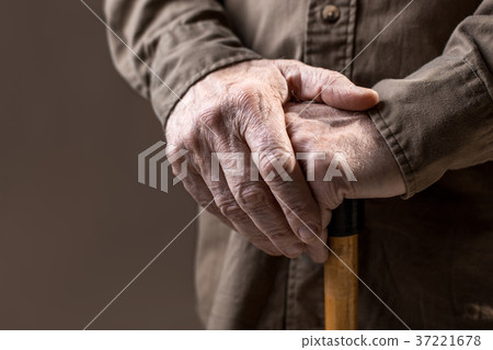 Male arms lying on cane 37221678