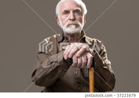 Thoughtful old man with walking stick 37221679