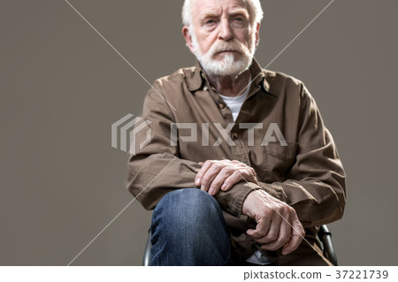 Hoary severe gaffer resting on stool 37221739