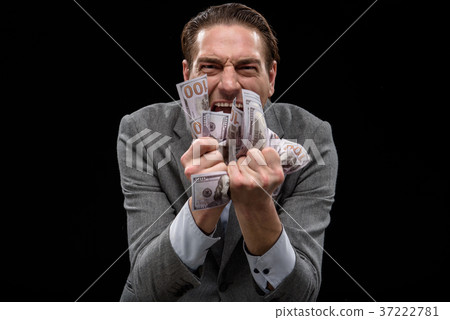 Rich young businessman is enjoying huge earnings 37222781