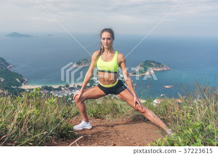 Fitness woman stretching her leg muscles doing 37223615