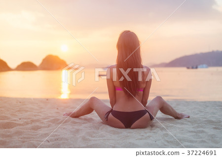 Back view of young female with long brown hair Back view of young female with long brown hair 37224691