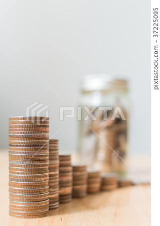 Coins stack step growing growth with coins in jar Coins stack step growing growth with coins in jar 37225095