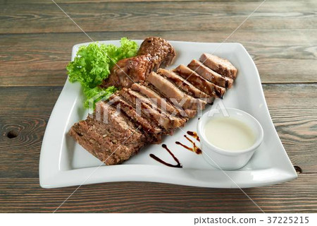 Slices of a stuffed meat with a garlic sauce 37225215